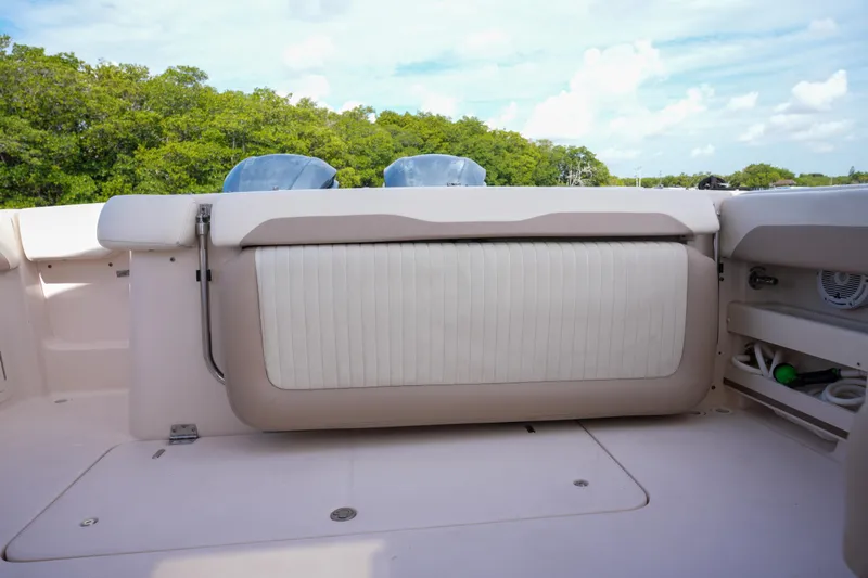  Yacht Photos Pics 2014 Grady-White Freedom 307 boat interior with seating and storage, surrounded by lush greenery.