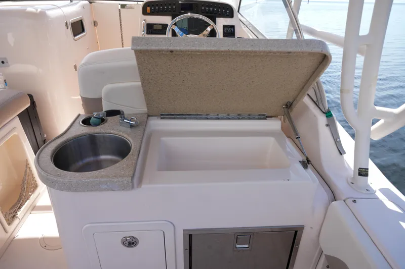  Yacht Photos Pics 2014 Grady-White Freedom 307 boat interior with sink and storage compartment.
