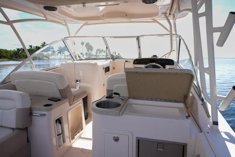  Yacht Photos Pics 2014 Grady-White Freedom 307 boat interior with seating and helm, overlooking serene water.