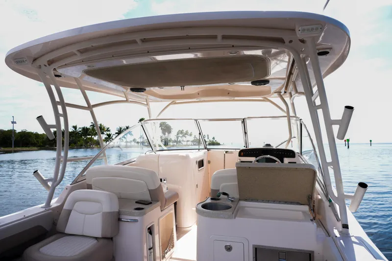  Yacht Photos Pics 2014 Grady-White Freedom 307 boat interior with seating and helm, on calm water.