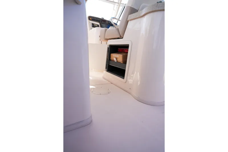  Yacht Photos Pics Interior view of 2014 Grady-White Freedom 307 boat, featuring storage compartment and seating area.