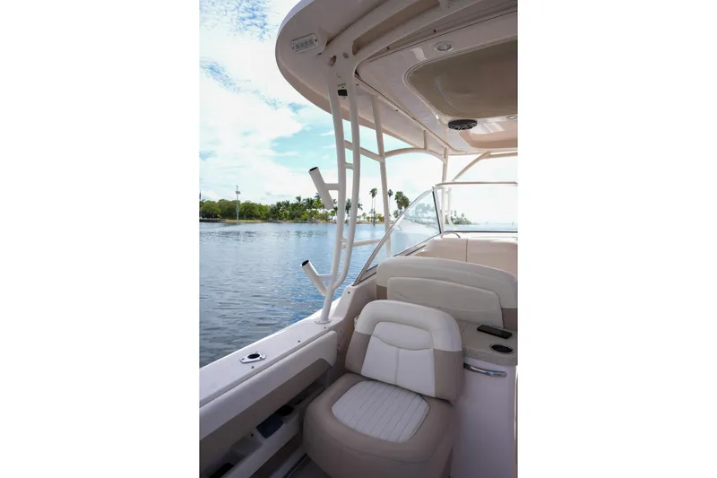  Yacht Photos Pics 2014 Grady-White Freedom 307 boat interior with seating, on calm water.