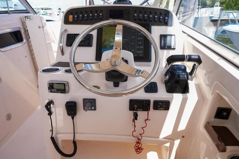  Yacht Photos Pics 2014 Grady-White Freedom 307 boat dashboard with steering wheel and control panel.