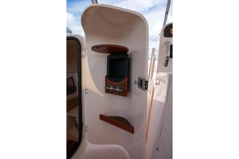  Yacht Photos Pics Interior view of 2014 Grady-White Freedom 307 boat cabin with storage compartments.