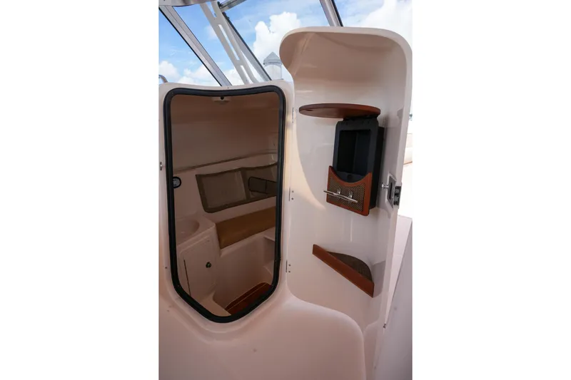  Yacht Photos Pics 2014 Grady-White Freedom 307 cabin interior with storage and seating.