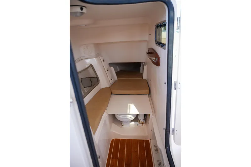  Yacht Photos Pics 2014 Grady-White Freedom 307 cabin interior with seating and wooden flooring.