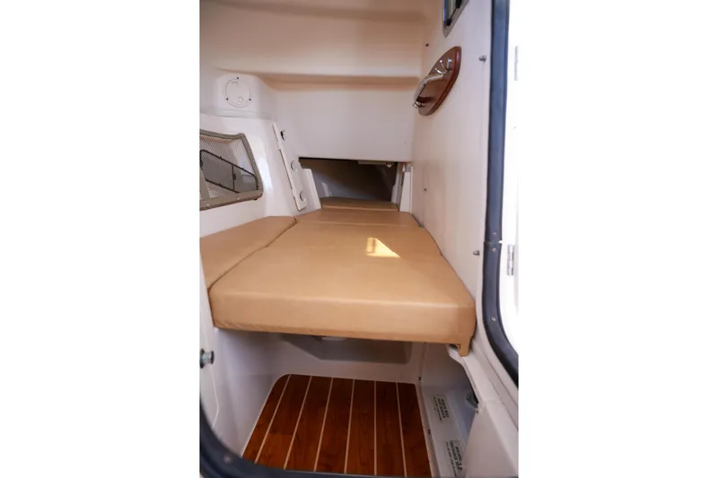  Yacht Photos Pics 2014 Grady-White Freedom 307 cabin interior with cushioned seating and wooden flooring.