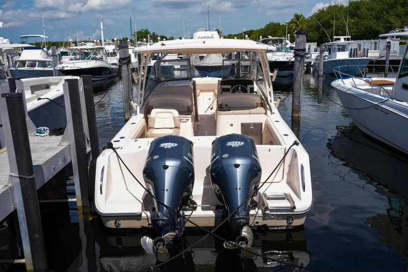  Yacht Photos Pics 2014 Grady-White Freedom 307 boat docked in a marina, featuring dual engines.