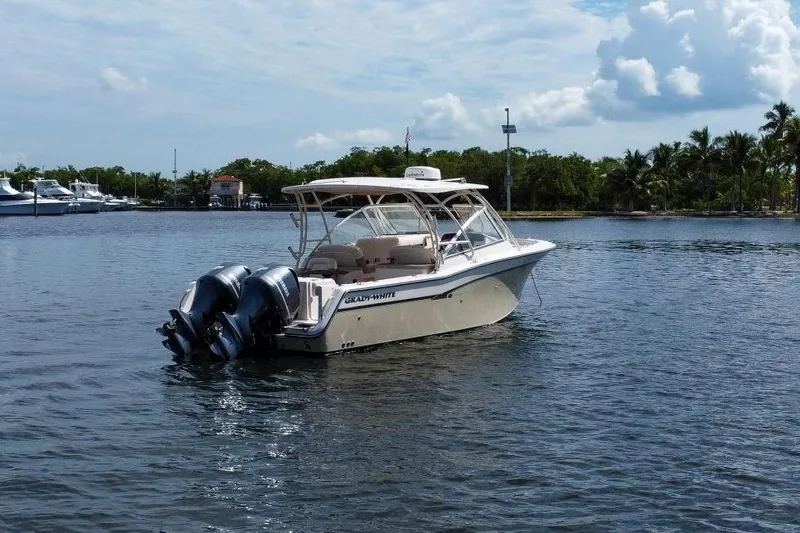  Yacht Photos Pics 2014 Grady-White Freedom 307 boat on calm water, with twin outboard engines.