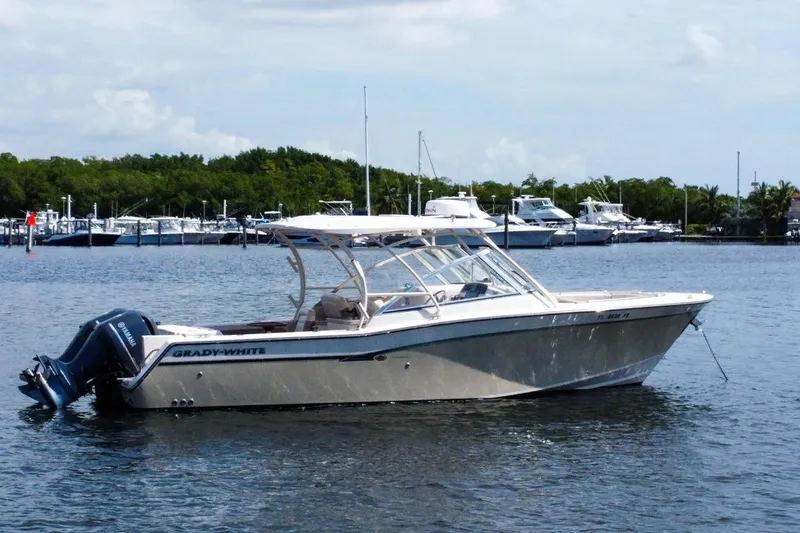  Yacht Photos Pics 2014 Grady-White Freedom 307 boat anchored on calm water near marina.