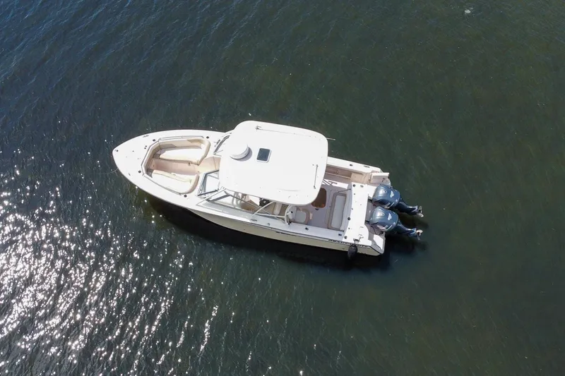 Yacht Photos Pics 2014 Grady-White Freedom 307 boat on calm water, aerial view.