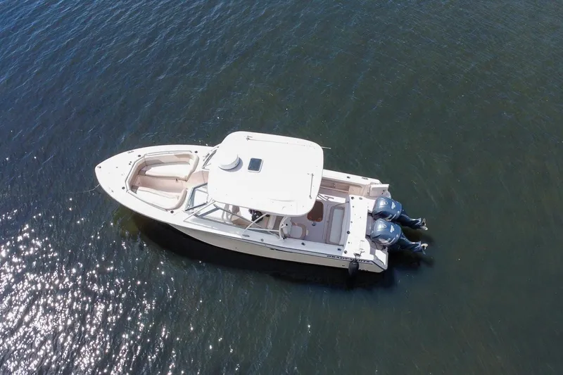  Yacht Photos Pics 2014 Grady-White Freedom 307 boat on calm water, aerial view.