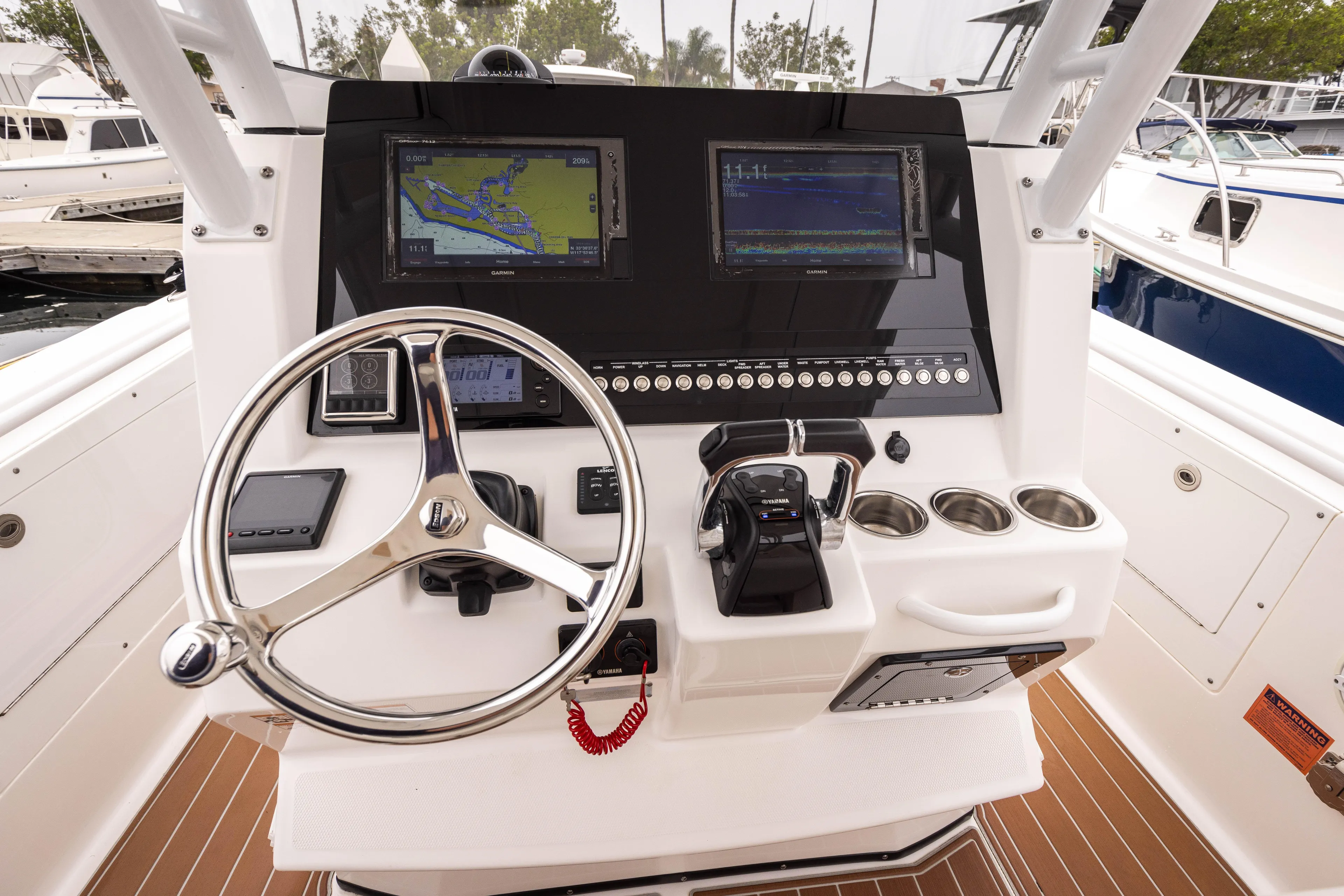 Pure Vida Yacht Photos Pics Edgewater 2017 Center Console boat dashboard with navigation screens and steering wheel.
