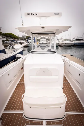Pure Vida Yacht Photos Pics 2017 Edgewater Center Console boat docked at marina, featuring Garmin equipment.