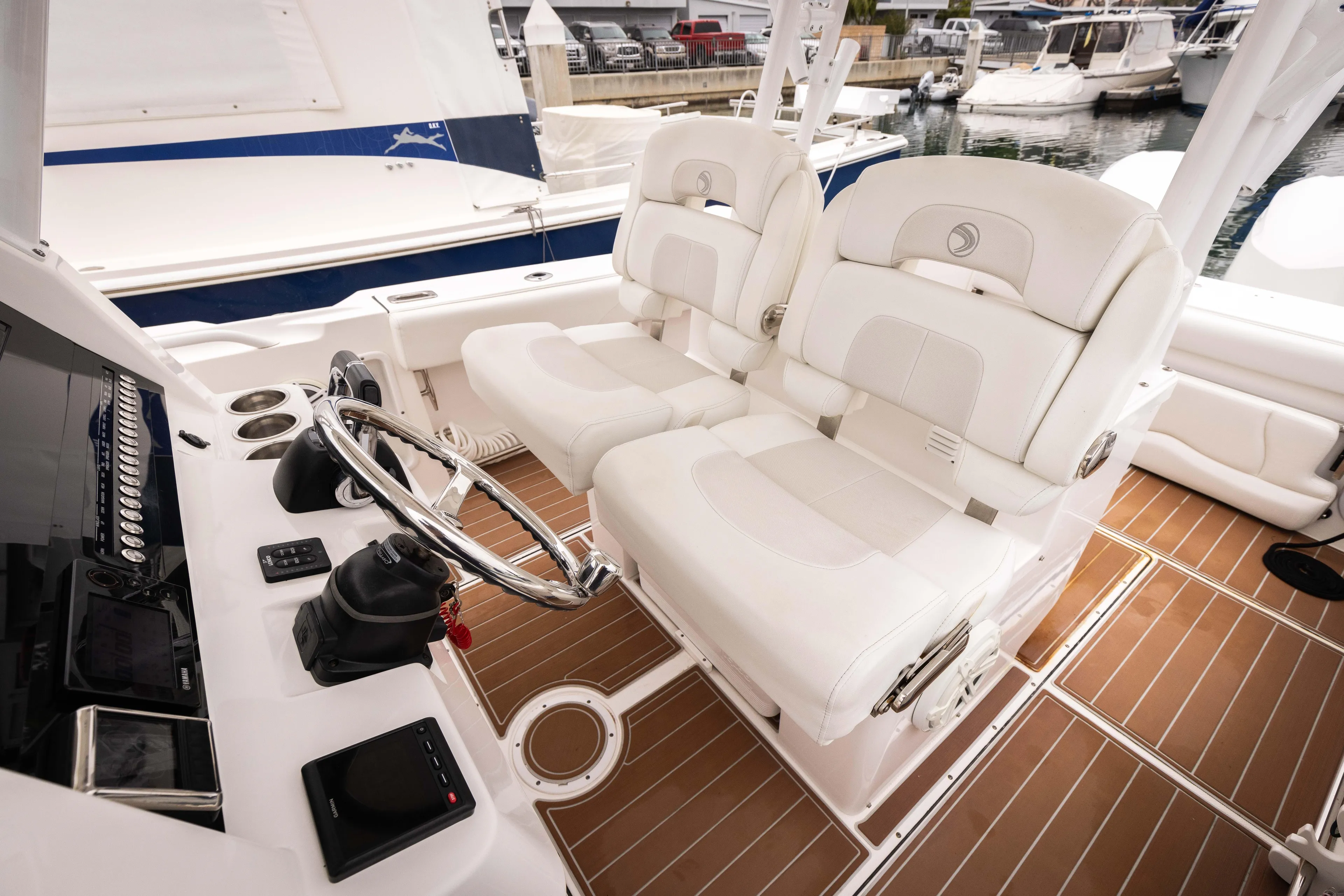 Pure Vida Yacht Photos Pics 2017 Edgewater Center Console boat interior with white seating and modern controls.