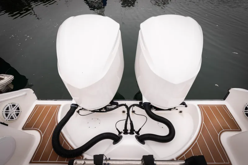 Pure Vida Yacht Photos Pics 2017 Edgewater Center Console boat with dual outboard motors on water.