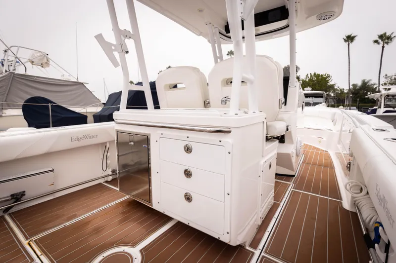 Pure Vida Yacht Photos Pics 2017 Edgewater Center Console boat interior with white seating and wood flooring.