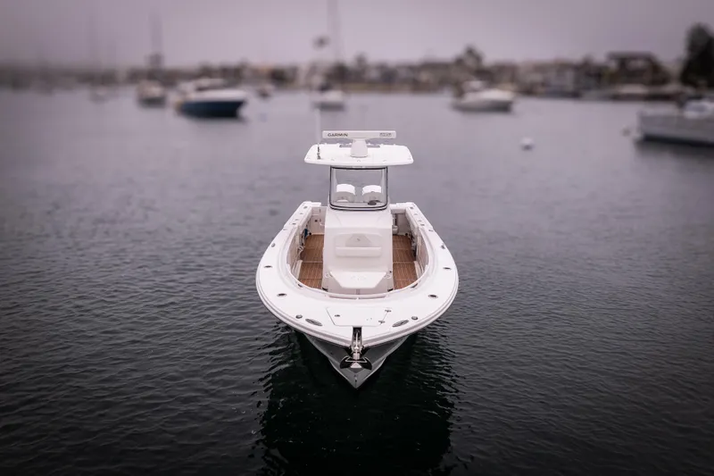 Pure Vida Yacht Photos Pics 2017 Edgewater Center Console boat on calm water, overcast sky.