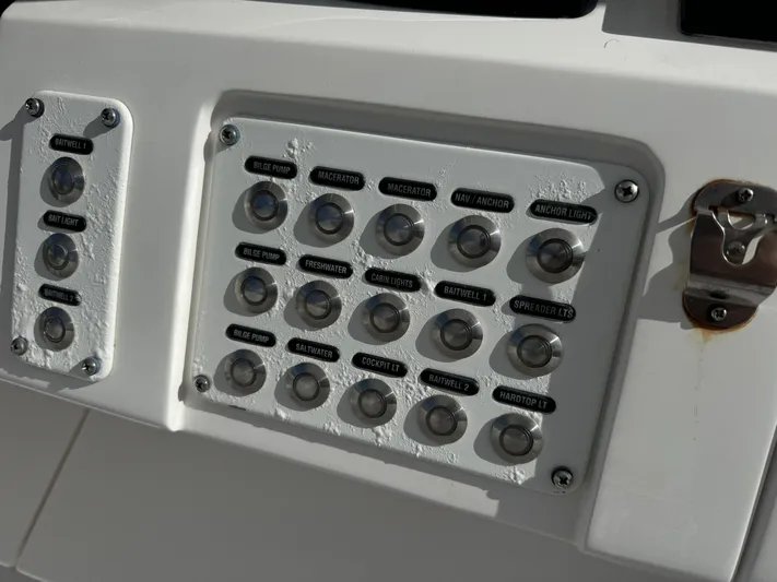 No Name Yacht Photos Pics Control panel of a 2014 Intrepid 327 Center Console boat with labeled switches.