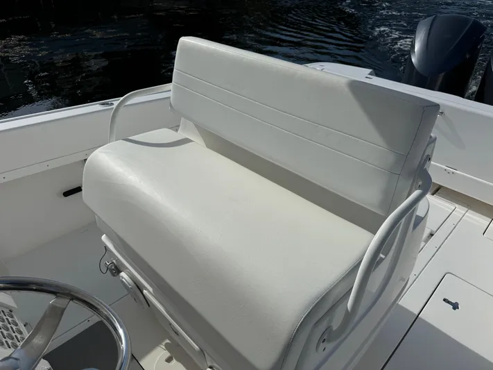 No Name Yacht Photos Pics White seating on 2014 Intrepid 327 Center Console boat, with water in the background.