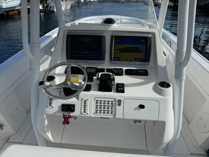 No Name Yacht Photos Pics 2014 Intrepid 327 Center Console boat dashboard with dual screens and steering wheel.