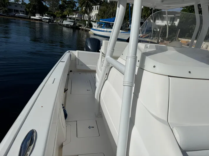 No Name Yacht Photos Pics 2014 Intrepid 327 Center Console boat docked by waterfront homes.