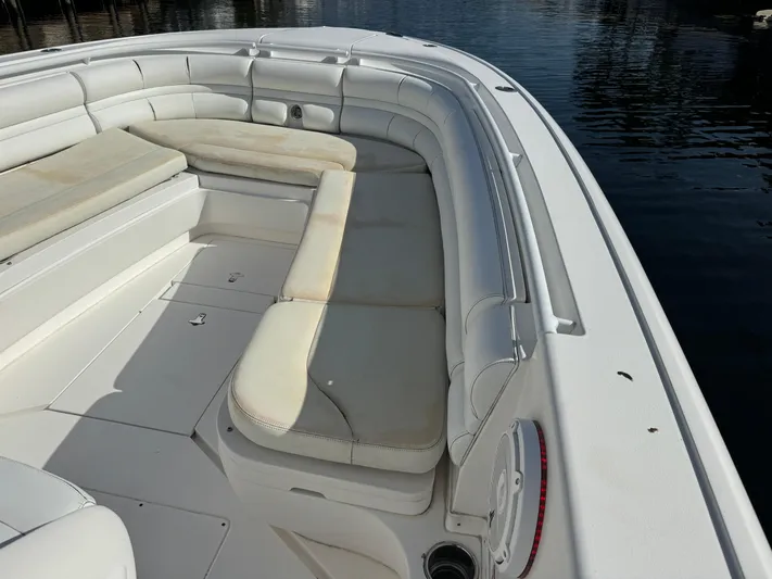 No Name Yacht Photos Pics 2014 Intrepid 327 Center Console boat with spacious seating, docked on calm water.