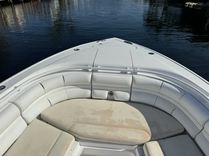 No Name Yacht Photos Pics 2014 Intrepid 327 Center Console boat with white cushioned seating, docked on calm water.