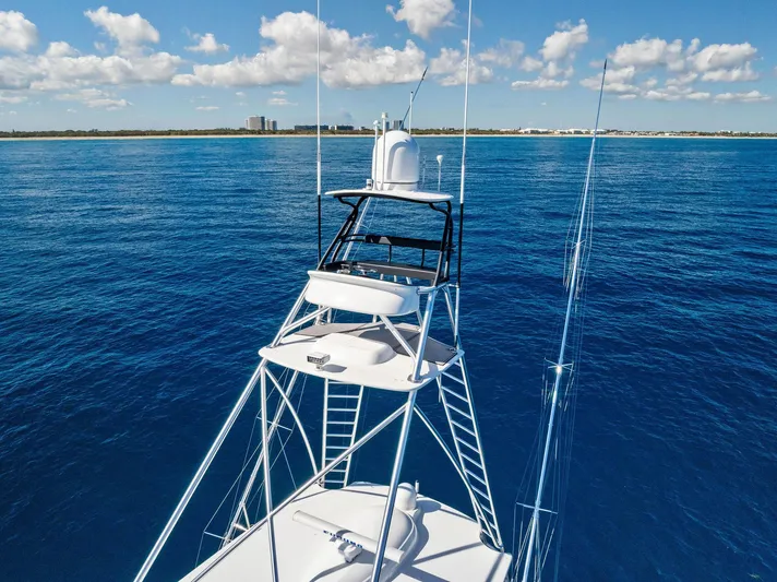  Yacht Photos Pics 2019 Viking 80 Convertible yacht on open sea with clear blue skies.