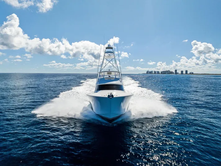  Yacht Photos Pics 2019 Viking 80 Convertible yacht cruising on open ocean under clear blue sky.