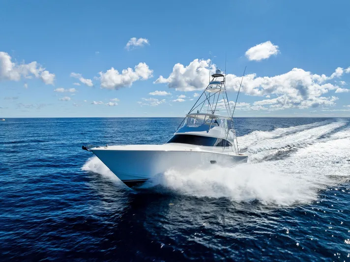  Yacht Photos Pics 2019 Viking 80 Convertible yacht cruising on open ocean under clear blue sky.