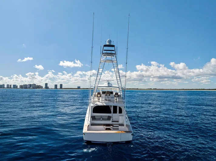  Yacht Photos Pics 2019 Viking 80 Convertible yacht on open sea with city skyline.