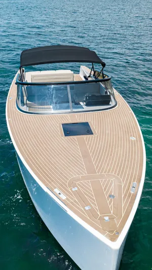  Yacht Photos Pics 2023 VanDutch 32 yacht with sleek design, wooden deck, and canopy on clear blue water.