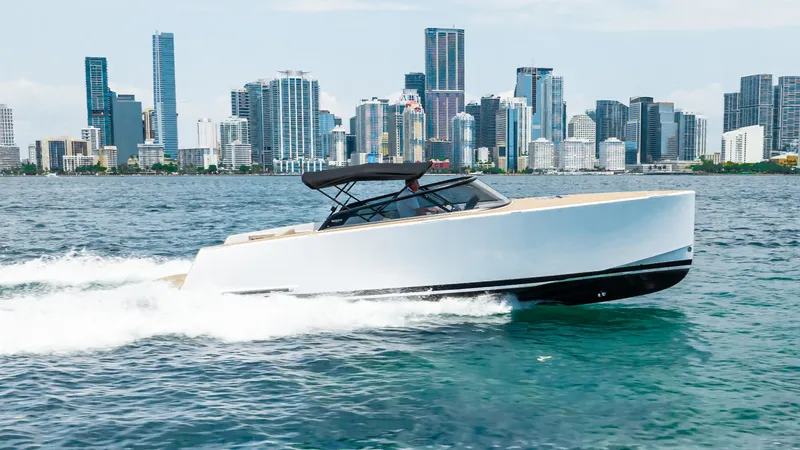  Yacht Photos Pics VanDutch 32 yacht cruising on water with city skyline in background, 2023 model.