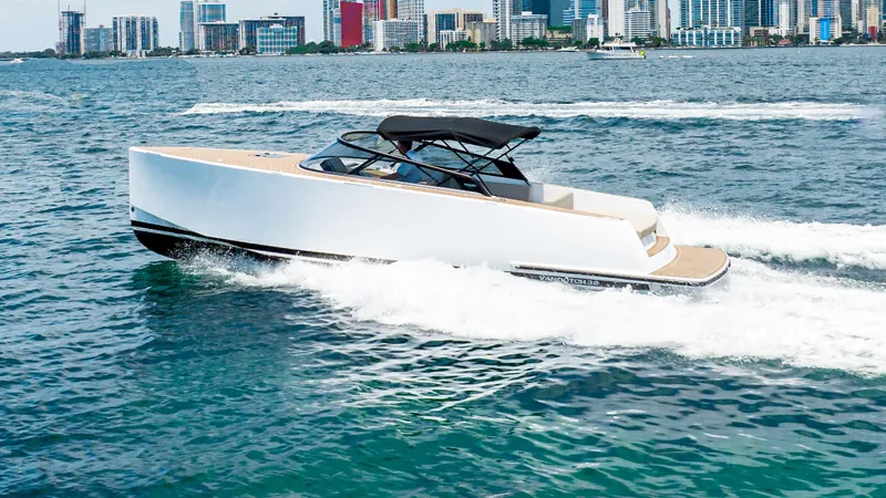  Yacht Photos Pics 2023 VanDutch 32 yacht cruising on water with city skyline in background.