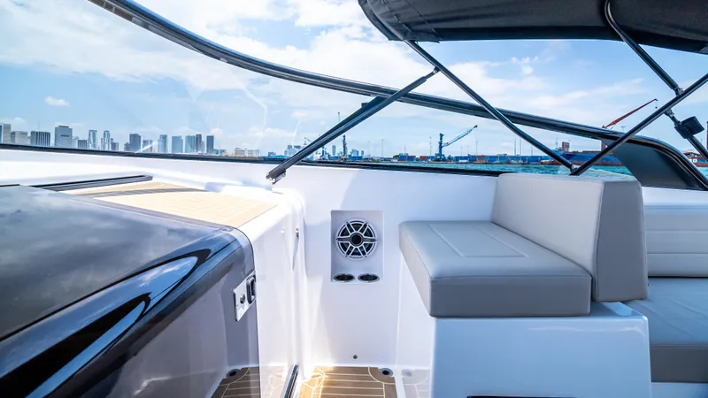 Yacht Photos Pics 2023 VanDutch 32 yacht interior with sleek seating and city skyline view.
