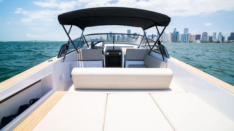  Yacht Photos Pics 2023 VanDutch 32 yacht with sleek design, cruising on open water near city skyline.