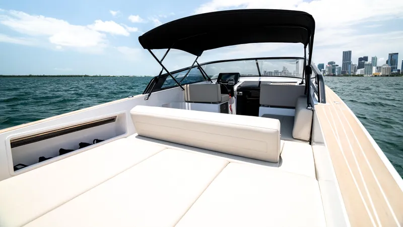  Yacht Photos Pics 2023 VanDutch 32 yacht on open water with city skyline in background.