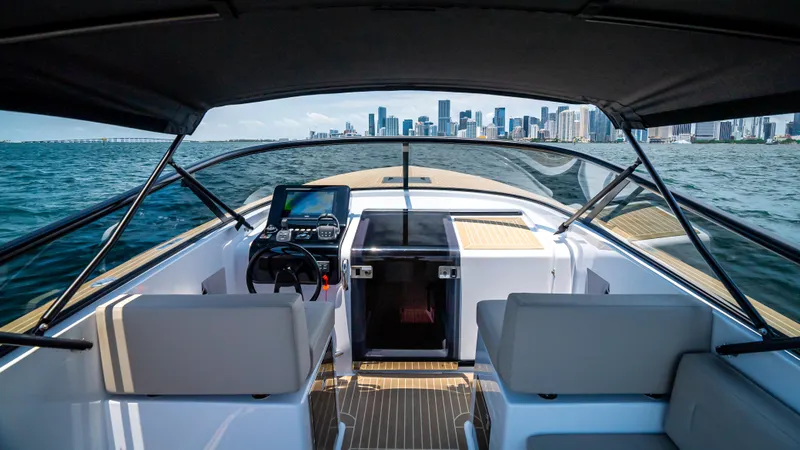  Yacht Photos Pics 2023 VanDutch 32 yacht interior with city skyline view, featuring modern design and navigation equipment.