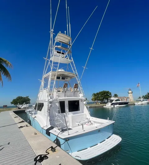  Yacht Photos Pics 1990 Hatteras 45 Convertible yacht docked at marina under clear blue sky.