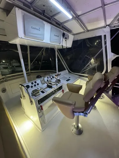  Yacht Photos Pics 1990 Hatteras 45 Convertible yacht helm with Garmin navigation, illuminated at night.
