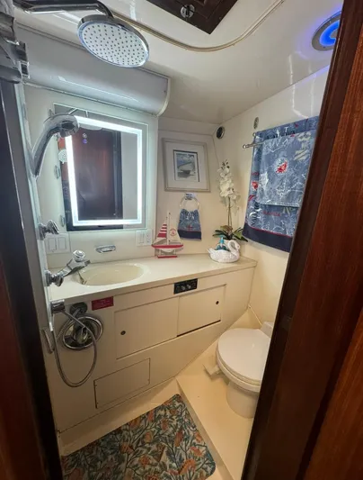  Yacht Photos Pics Bathroom interior of 1990 Hatteras 45 Convertible yacht, featuring nautical decor and modern amenities.