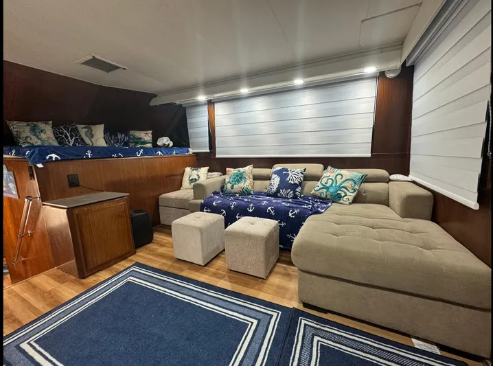  Yacht Photos Pics Luxurious interior of 1990 Hatteras 45 Convertible yacht with cozy seating and nautical decor.