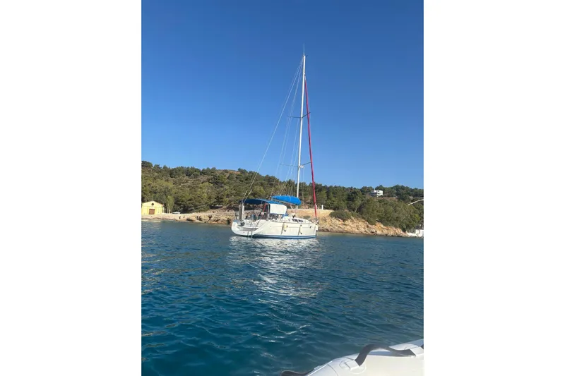  Yacht Photos Pics 2009 Jeanneau Sun Odyssey 39i sailboat anchored in scenic coastal waters.