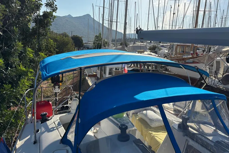  Yacht Photos Pics Jeanneau Sun Odyssey 39i sailboat, 2009 model, with blue canopy in a marina setting.