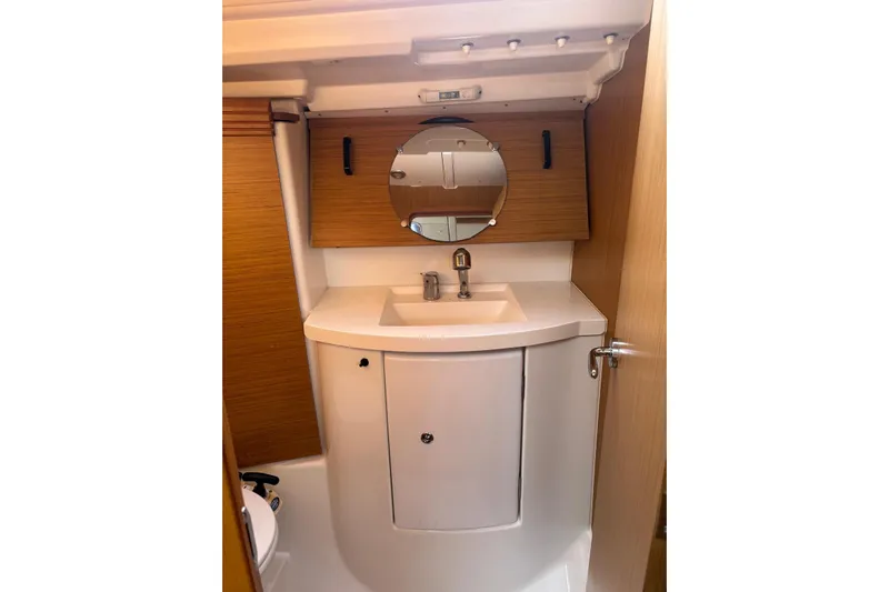  Yacht Photos Pics Bathroom interior of 2009 Jeanneau Sun Odyssey 39i yacht with sink and mirror.