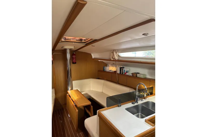 Yacht Photos Pics Interior of 2009 Jeanneau Sun Odyssey 39i yacht with modern kitchen and seating area.