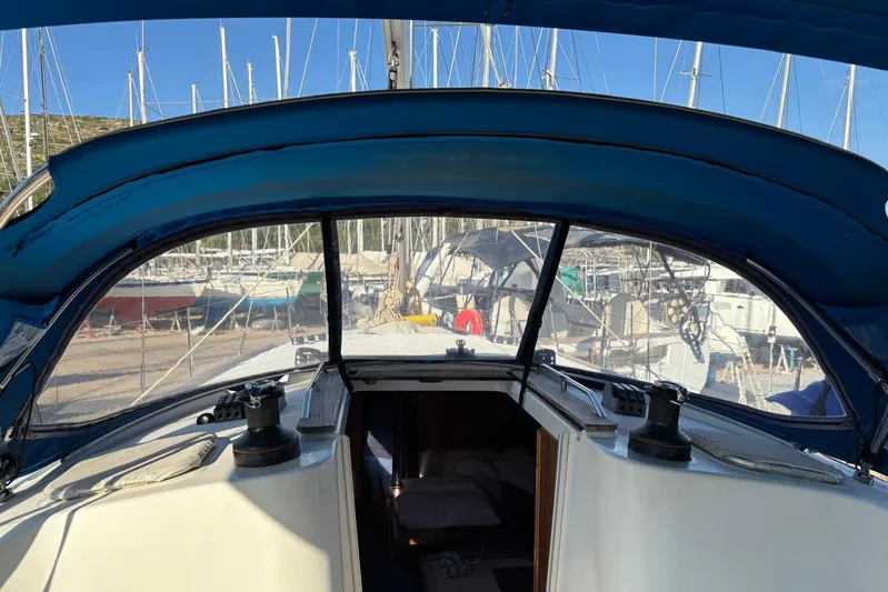  Yacht Photos Pics 2009 Jeanneau Sun Odyssey 39i sailboat cockpit with blue canopy and marina view.