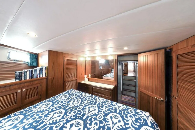 My Lindavia Yacht Photos Pics Luxurious 2012 Kadey-Krogen 44 yacht bedroom with wooden interior and patterned bedding.