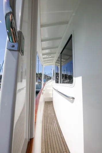 My Lindavia Yacht Photos Pics Side deck of 2012 Kadey-Krogen 44 yacht with wooden flooring and white exterior.